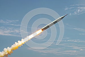 A large military ballistic rockets are take off in the blue sky