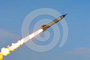 A large military ballistic rockets are take off in the blue sky