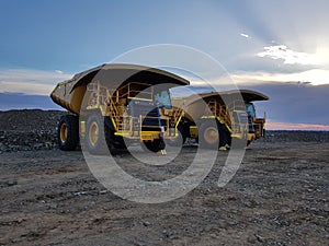 Large mine mining earth moving trucks construction twilight