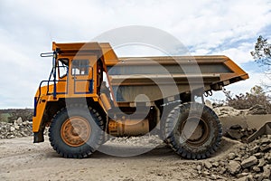 Large mining dump truck. Transport industry. Extraction of stone in an open pit