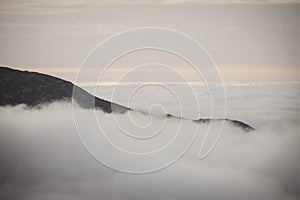 Large misty cloud climbing mountain valley in slovakia, Tatra - vintage retro look