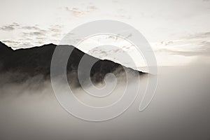 Large misty cloud climbing mountain valley in slovakia, Tatra - vintage retro look