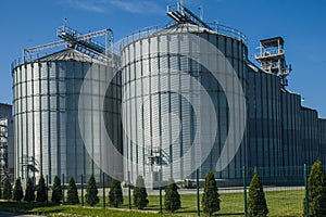 A large modern agro-processing plant for the storage and processing of grain crops. Fragment of large metal barrels of grain.