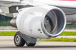 Large modern aircraft view of the huge engine and chassis, the light of the sun.