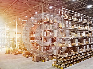 Large modern blurred warehouse industrial and logistics companies. Warehousing on the floor and called the high shelves