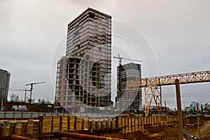 A large modern construction site in the construction of buildings and houses with appliances and many large high tower