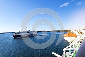 Large modern cruise ship in the sea. Beautiful white giant luxury cruise ship at harbour. Colorful landscape with boats in marina