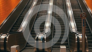 Large modern escalator in subway. Deserted escalator without people on four lanes that move up and down