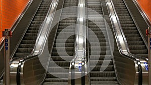 Large modern escalator in subway. Deserted escalator without people on four lanes that move up and down