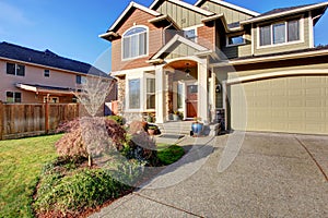 Large modern house with driveway, and garage.