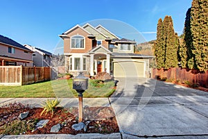 Large modern house with driveway, and garage.