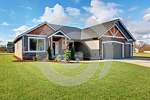 Large modern house with stone and walkway.