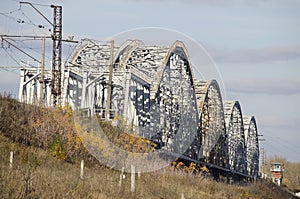 Large modern railway metal bridge over the river