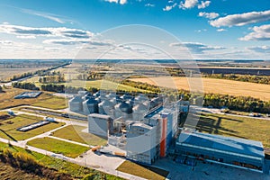 Large modern silos granary steel tanks or containers for silos, wheat and other cereals. Industrial agriculture, aerial view