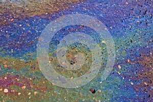 large multi-colored gasoline stain on the asphalt close-up
