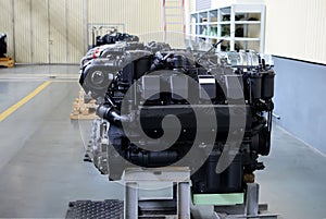 Large new diesel engines with turbines in the workshop of the factory for the production of trucks.
