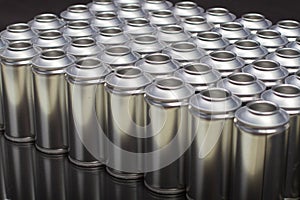 A large number of aerosol cans on a black background