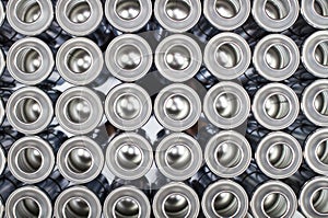 A large number of aerosol cans on a black background