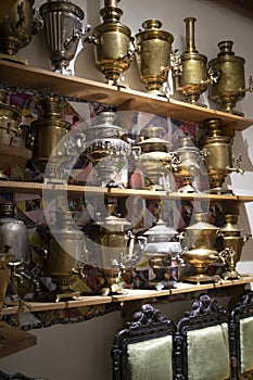 A large number of antique samovars on shelves, Belarus