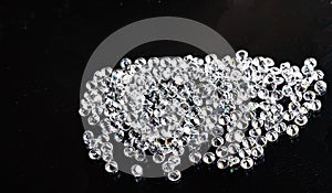 a large number of beautiful expensive diamonds on a black background refract light rays photo