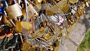 Large number of golden love locks (padlocks) locked to a fence by sweethearts on Montmartre hill in Paris, France.