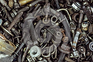 A large number of old rusty and oil-stained car parts