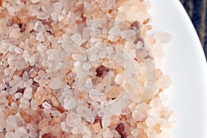 A large number of pink salt crystals of different sizes