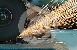 A large number of sparks when cutting a square metal tube.