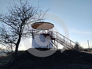 Large observation gazebo on the hill at sunset