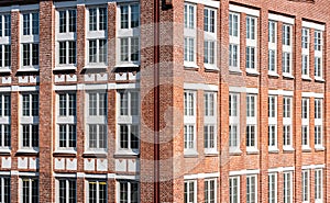 Large office building in brick with huge white windows