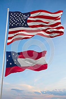 Large official Flag of US and Confederate States of America March 1861 state, Usa at cloudy sky background. United states of