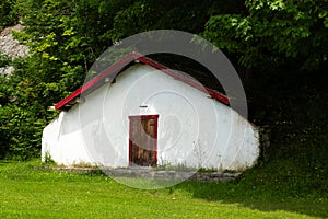 Large old 19th Century plastered stone white root cellar with sturdy wooden door