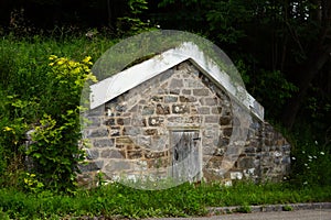 Large old 19th Century stone root cellar with sturdy wooden door