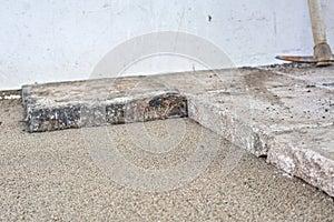 Large old concrete tile blocks on layer of sand - pavement construction, closeup detail