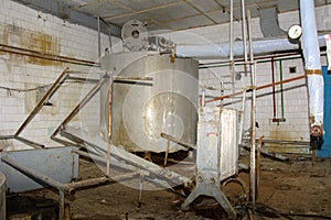 A large old dismantled and rusty tank for collecting milk