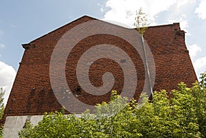 A large, old industrial building made of red brick.