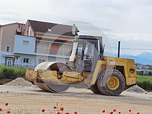 Large old roller on gravel road