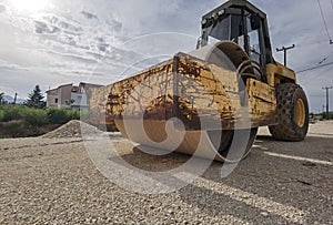 Large old roller on gravel road