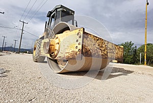 Large old roller on gravel road