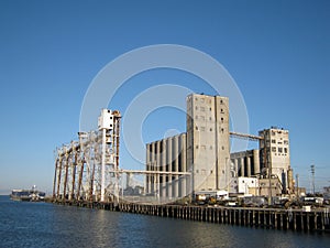 Large old rundown cement factory along the water