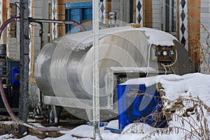 A large old tank for collecting milk in an abandoned