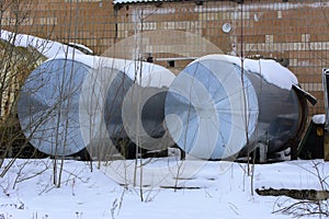 A large old tank for collecting milk in an abandoned