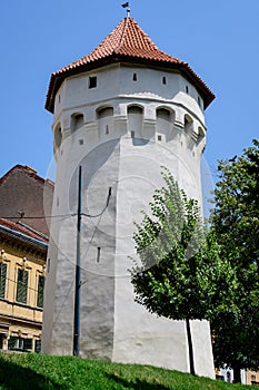 Large old white painted stone tower in the historical center of the Sibiu city, near Citadel Street and Park Strada si Parcul