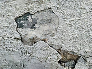 Large old window in a wooden frame. Brick house with shabby pale green paint.