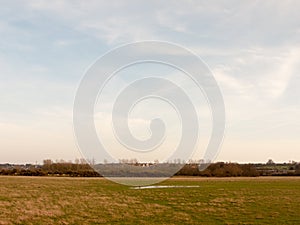 large open farm field empty grass grassland spring sky