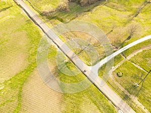 the large open field is next to a road with a sign pointing the way