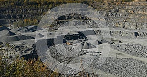 Large open iron ore quarry, panorama of a large stone quarry, equipment in the quarry, open pit working process, quarry