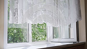 Large open plastic window with thin transparent curtain