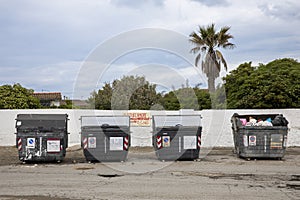 Large open trash cans with garbage strewn everywhere, it's just rudeness