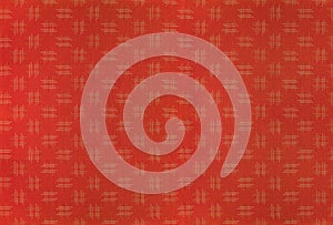 Large orange background of a traditional japanese fabric printed with a design of igeta sharps or hashtags pattern.